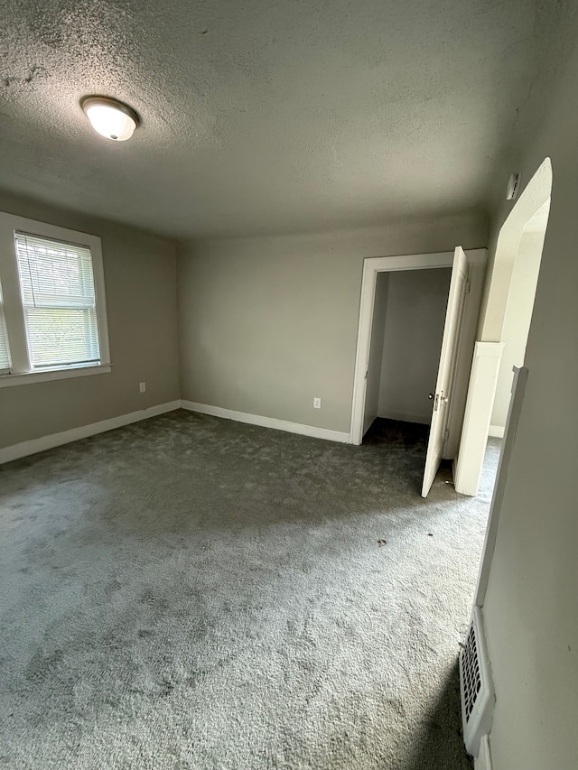 7130 Julian St, Detroit, MI 48204 - unfurnished bedroom featuring a textured ceiling, carpet, and baseboards