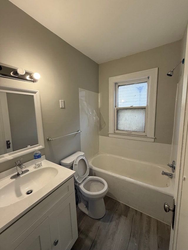 7130 Julian St, Detroit, MI 48204 - bathroom with wood finished floors, vanity, toilet, and tub / shower combination