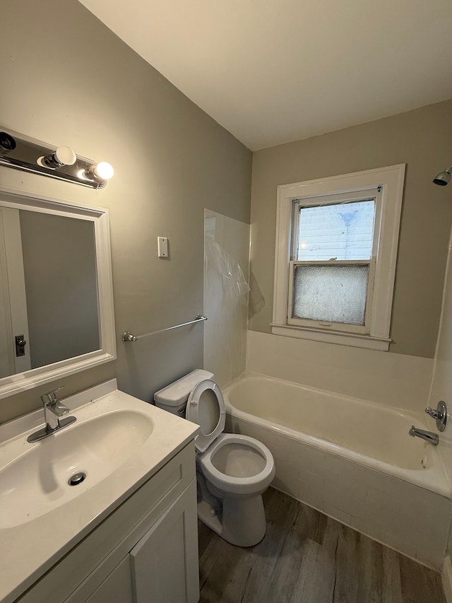 7130 Julian St, Detroit, MI 48204 - full bathroom with a bathtub, wood finished floors, vanity, toilet, and a shower