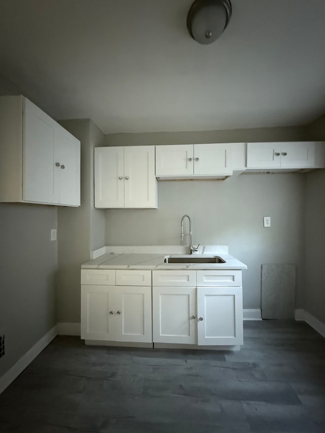 7130 Julian St, Detroit, MI 48204 - kitchen with a sink, baseboards, white cabinetry, and dark wood finished floors