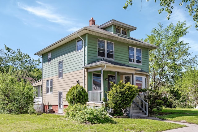 923 Calvert St, Detroit, MI 48202 - american foursquare style home featuring a porch, a chimney, and a front lawn