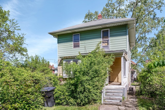 923 Calvert St, Detroit, MI 48202 - back of property featuring a chimney and a shingled roof