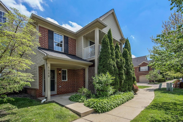 4049 Berkeley Ave Unit 25, Canton, MI 48188 - traditional-style home featuring brick siding, a front lawn, and a balcony