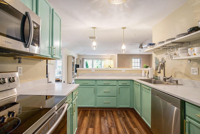 4049 Berkeley Ave Unit 25, Canton, MI 48188 - kitchen with appliances with stainless steel finishes, a sink, green cabinets, dark wood-type flooring, and light countertops