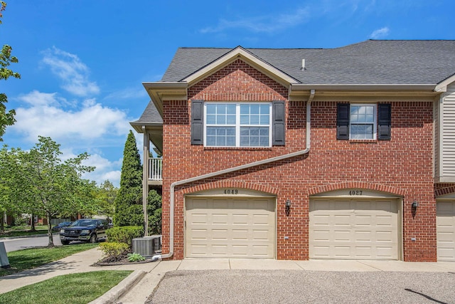 4049 Berkeley Ave Unit 25, Canton, MI 48188 - multi unit property with an attached garage, a shingled roof, brick siding, and central AC unit