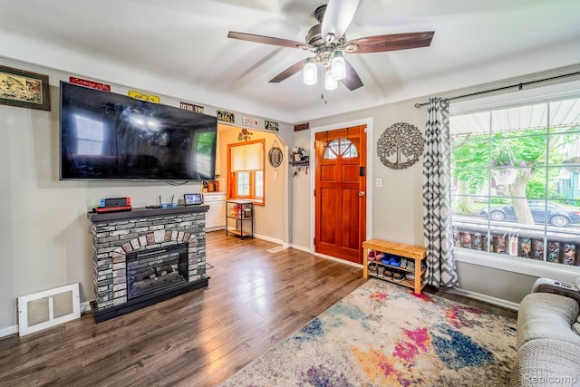 706 White Ave, Lincoln Park, MI 48146 - living room featuring wood finished floors, a ceiling fan, baseboards, and a fireplace