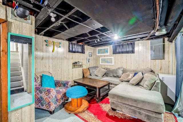 706 White Ave, Lincoln Park, MI 48146 - living area featuring wooden walls, electric panel, concrete floors, and stairs