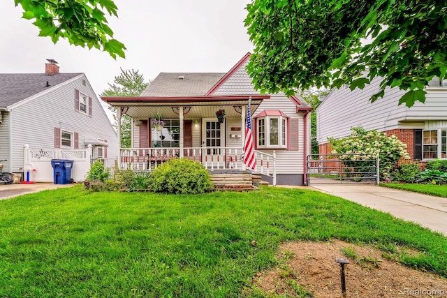 706 White Ave, Lincoln Park, MI 48146 - victorian house with covered porch and a gate