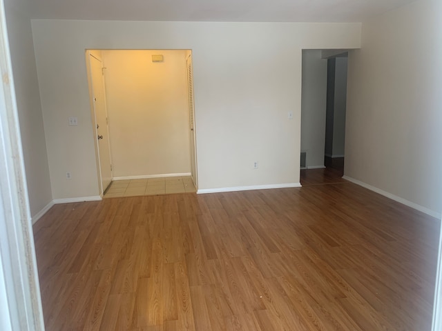 311 W Highland Rd Unit T13, Howell, MI 48843 - empty room with light wood-style flooring and baseboards