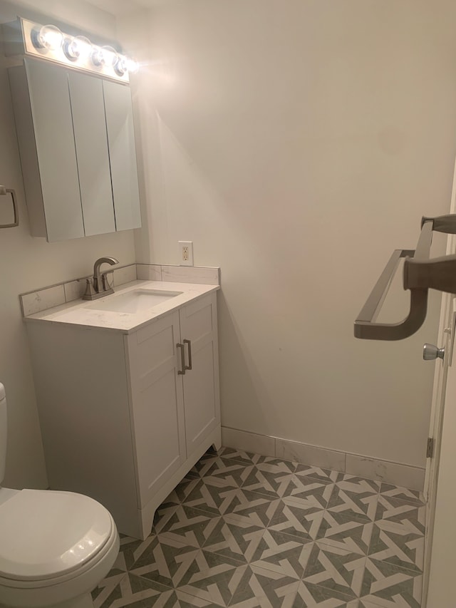 311 W Highland Rd Unit T13, Howell, MI 48843 - half bath featuring toilet, vanity, tile patterned floors, and baseboards