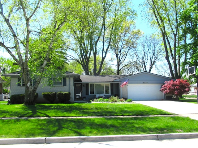 34495 Wood St, Livonia, MI 48154 - tri-level home featuring an attached garage, brick siding, concrete driveway, and a front yard