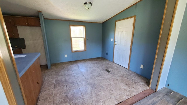 7939 W Moore Rd, Ravenna, MI 49451 - unfurnished dining area with crown molding