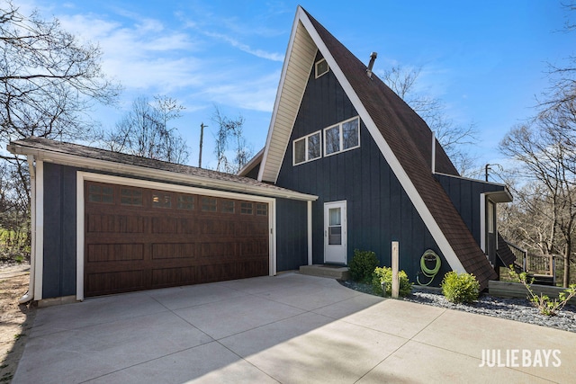 a-frame home featuring driveway and a garage