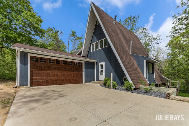 a-frame style home featuring driveway and an attached garage