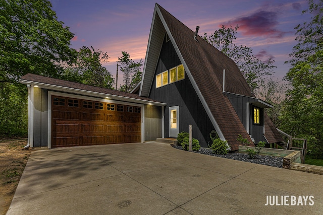 a-frame style home with a garage and concrete driveway