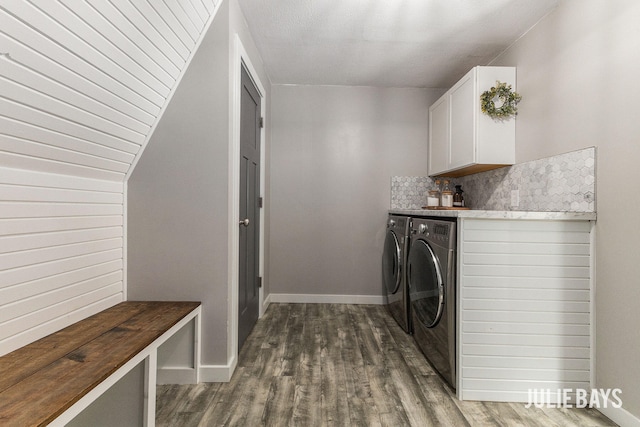 laundry room with independent washer and dryer, cabinet space, wood finished floors, and baseboards
