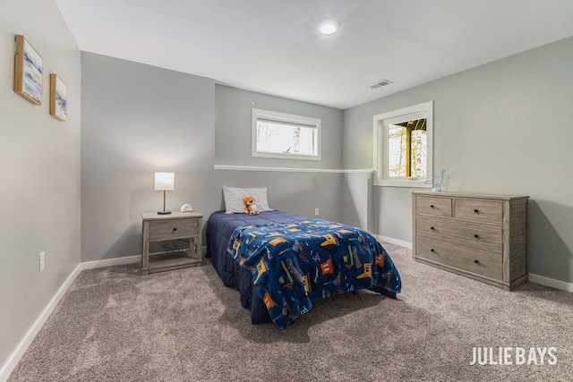 bedroom featuring carpet and baseboards