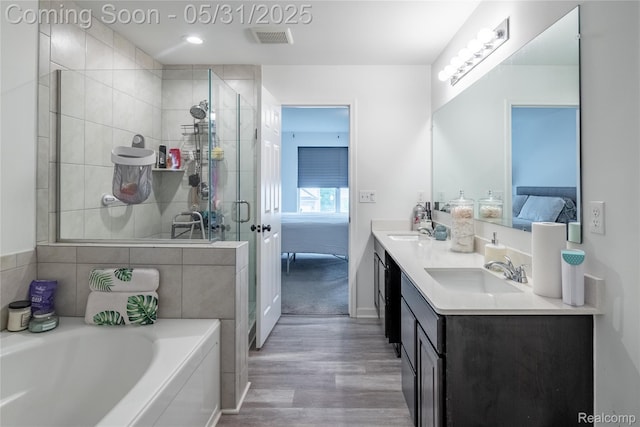 9480 White Tail Dr, Ypsilanti, MI 48197 - full bathroom featuring ensuite bathroom, wood finished floors, double vanity, and a garden tub