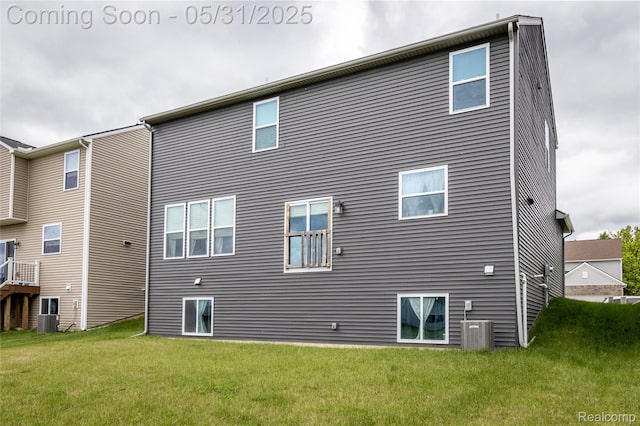 9480 White Tail Dr, Ypsilanti, MI 48197 - back of house featuring a lawn and central air condition unit
