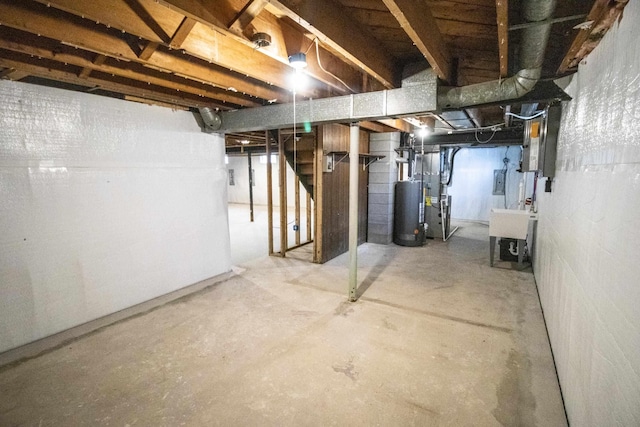 unfinished below grade area with gas water heater, stairs, and a sink