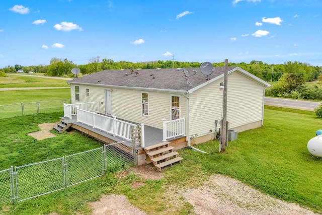 10060 Pioneer Rd, Hillsdale, MI 49242 - rear view of house with a wooden deck, a gate, and a shingled roof