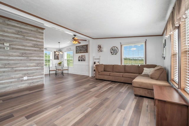 10060 Pioneer Rd, Hillsdale, MI 49242 - living room featuring wood finished floors, a textured ceiling, ornamental molding, a ceiling fan, and a decorative wall