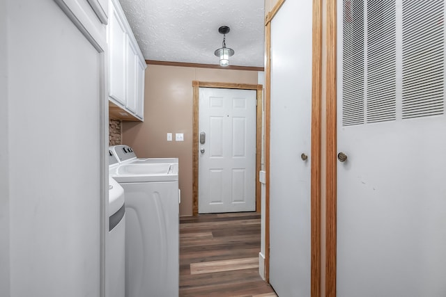 10060 Pioneer Rd, Hillsdale, MI 49242 - washroom with a heating unit, washer and clothes dryer, cabinet space, and dark wood finished floors