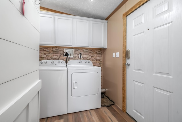 10060 Pioneer Rd, Hillsdale, MI 49242 - laundry room featuring cabinet space, washing machine and dryer, a textured ceiling, wood finished floors, and baseboards