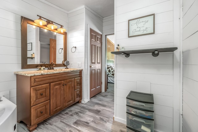 10060 Pioneer Rd, Hillsdale, MI 49242 - full bathroom featuring wood finished floors, wooden walls, vanity, and a bath