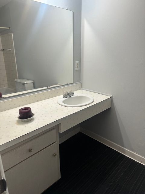 25300 Shiawassee Cir, Southfield, MI 48033 - full bath featuring vanity, toilet, baseboards, bathtub / shower combination, and wood finished floors