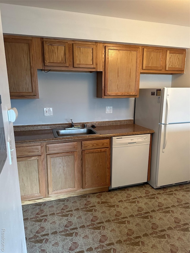 25300 Shiawassee Cir, Southfield, MI 48033 - kitchen featuring white appliances, a sink, dark countertops, and brown cabinets