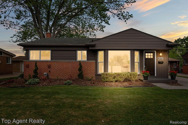 32525 Holden Dr, Warren, MI 48092 - view of front of home with a chimney, a front lawn, and brick siding