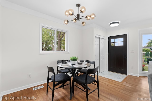 32525 Holden Dr, Warren, MI 48092 - dining area featuring a chandelier, light wood-type flooring, and baseboards