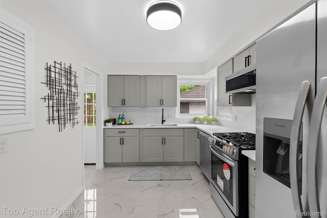 32525 Holden Dr, Warren, MI 48092 - kitchen featuring stainless steel appliances, gray cabinetry, a sink, and plenty of natural light