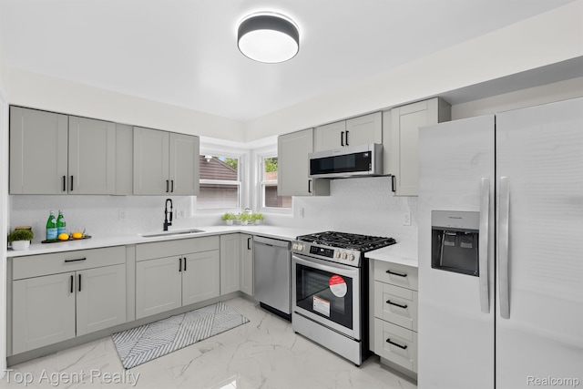 32525 Holden Dr, Warren, MI 48092 - kitchen featuring stainless steel appliances, a sink, gray cabinets, light marble finish flooring, and light countertops
