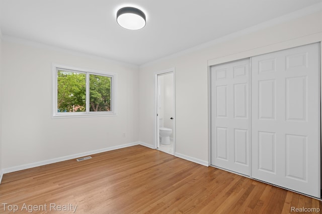 32525 Holden Dr, Warren, MI 48092 - unfurnished bedroom with baseboards, light wood finished floors, a closet, ensuite bathroom, and ornamental molding