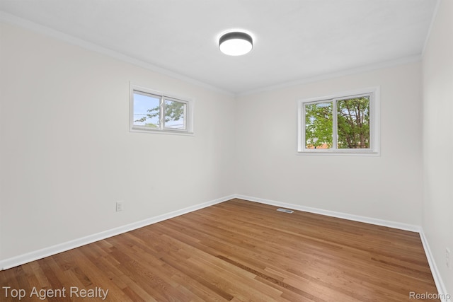 32525 Holden Dr, Warren, MI 48092 - unfurnished room with crown molding, plenty of natural light, baseboards, and light wood-style floors