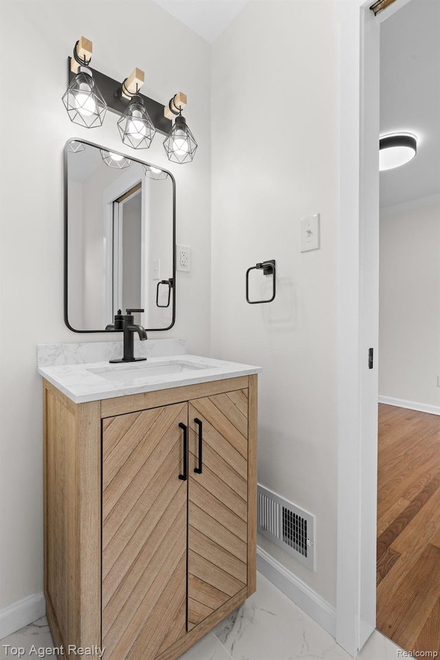 32525 Holden Dr, Warren, MI 48092 - bathroom with vanity, baseboards, and marble look tiles