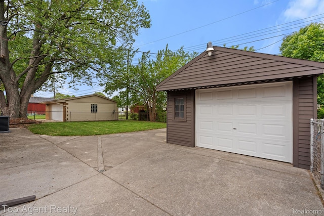 32525 Holden Dr, Warren, MI 48092 - detached garage featuring driveway and cooling unit
