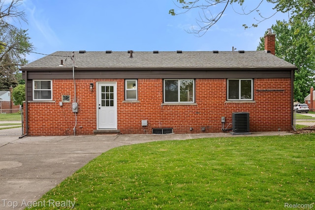 32525 Holden Dr, Warren, MI 48092 - back of house with a chimney, brick siding, roof with shingles, and cooling unit
