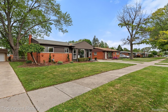 32525 Holden Dr, Warren, MI 48092 - single story home with brick siding, a chimney, a front yard, and driveway