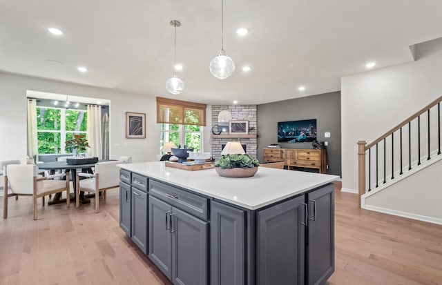 5136 Barnes Rd, Canton, MI 48188 - kitchen with light wood-type flooring, light countertops, gray cabinets, a kitchen island, and recessed lighting