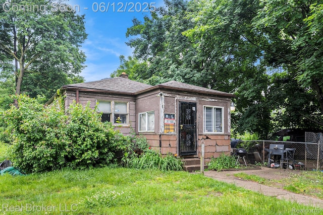 15036 Blackstone St, Detroit, MI 48223 - view of front of house featuring entry steps, roof with shingles, and a chimney