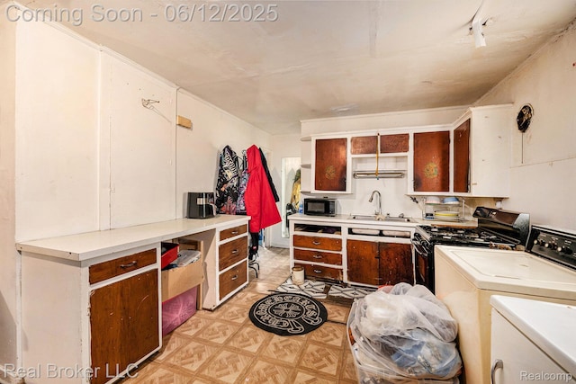 15036 Blackstone St, Detroit, MI 48223 - kitchen with separate washer and dryer, a sink, light floors, light countertops, and open shelves
