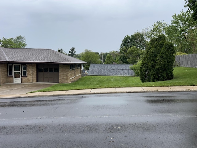 805 Capen St NE, Grand Rapids, MI 49505 - view of property exterior featuring an attached garage, brick siding, a shingled roof, and concrete driveway