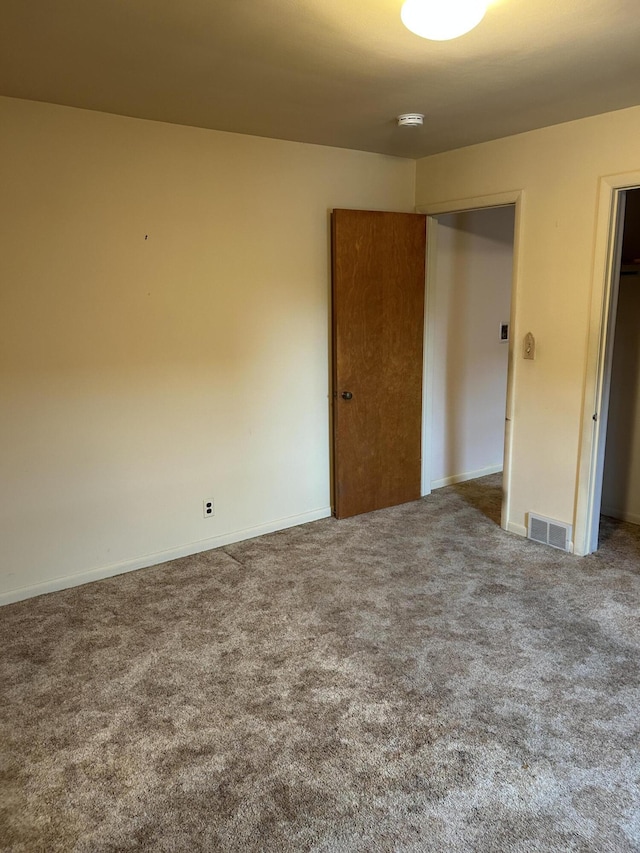 805 Capen St NE, Grand Rapids, MI 49505 - unfurnished bedroom with carpet flooring, baseboards, and a closet