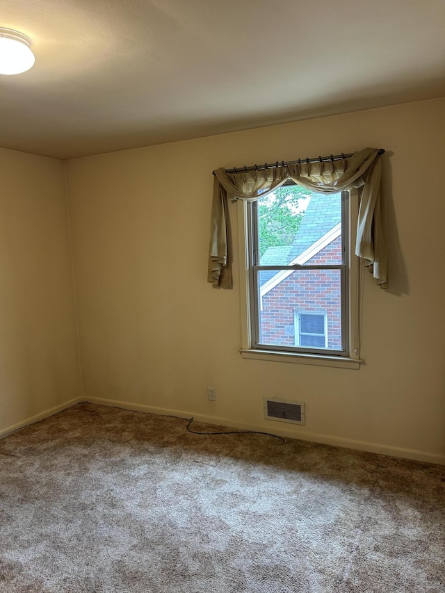 805 Capen St NE, Grand Rapids, MI 49505 - spare room featuring carpet flooring and baseboards