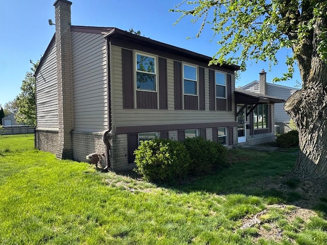 14127 Marie St, Livonia, MI 48154 - view of side of home with a chimney and brick siding