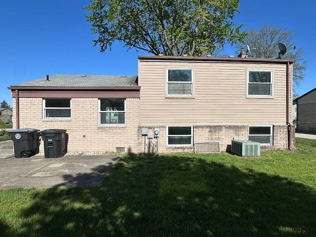 14127 Marie St, Livonia, MI 48154 - rear view of property with central air condition unit, a yard, and a patio area