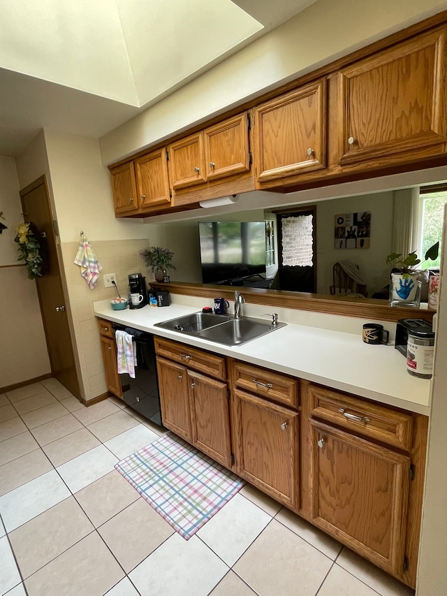 15091 Sebastian Ct, Shelby Twp, MI 48315 - kitchen with a sink, dishwasher, brown cabinets, and light countertops